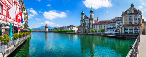 Panoramic view of Lucerne (Luzern) town with famous Chapel wooden bridge over Reuss river and Jesuit Church.  Switzerland travel and landmarks.