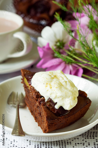 Obraz na płótnie Chocolate plum cake with whipped cream, served with cocoa. Rustic style. w salonie