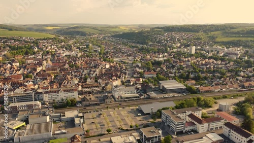 Drone shot over a cityscape of Bad Mergentheim with trees and green landscape on a sunny day photo