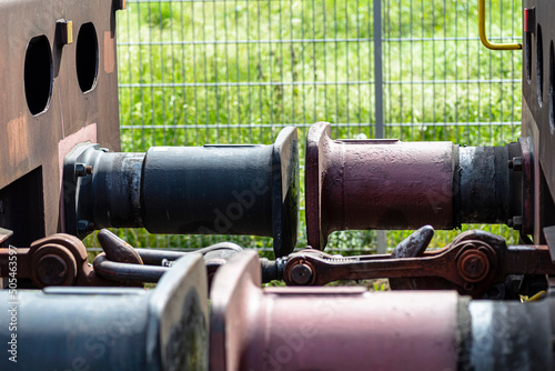 Chain coupler connecting freight wagons, large wagon buffers visible. © Michal