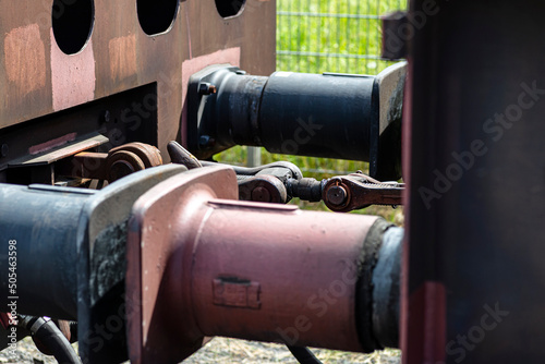 Chain coupler connecting freight wagons, large wagon buffers visible. © Michal