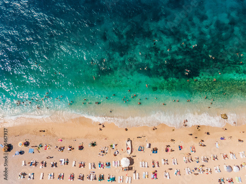 Fototapeta Naklejka Na Ścianę i Meble -  Drone footage of people sunbathing on Kaputaş beach near Kalkan - Kaş, Antalya, Turkey