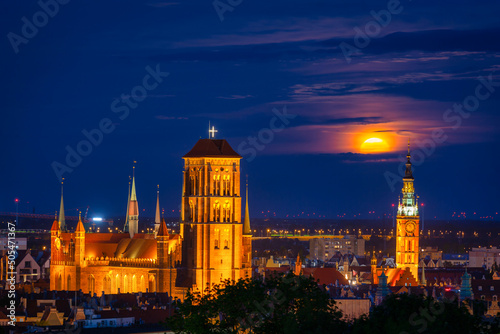 A full moon rising over the city of Gdansk at dusk, Poland