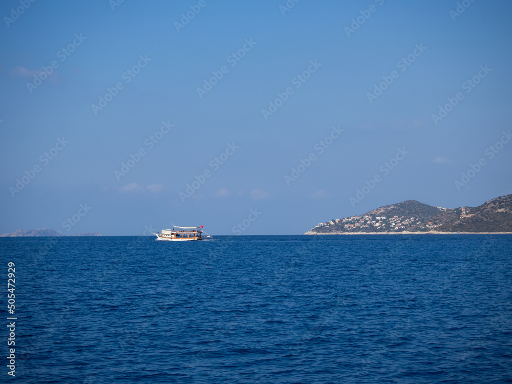Tour boat sailing towards the sea with passengers Kaş, Antalya Turkey