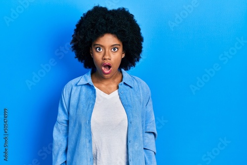 Young african american woman wearing casual clothes afraid and shocked with surprise and amazed expression, fear and excited face.
