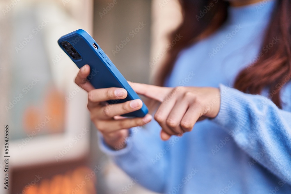 Young hispanic woman using smartphone at street Young hispanic woman using smartphone at street