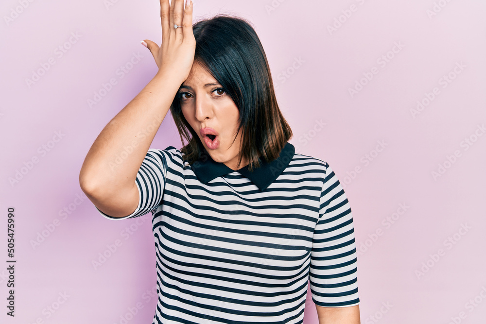 Young hispanic woman wearing casual clothes surprised with hand on head for mistake, remember error. forgot, bad memory concept. Young hispanic woman wearing casual clothes surprised with hand on head for mistake, remember error. forgot, bad memory concept.