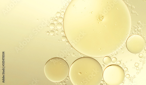 Abstract various yellow bubbles oil or serum with copy space background banner. cosmetic or spa ingredient concept