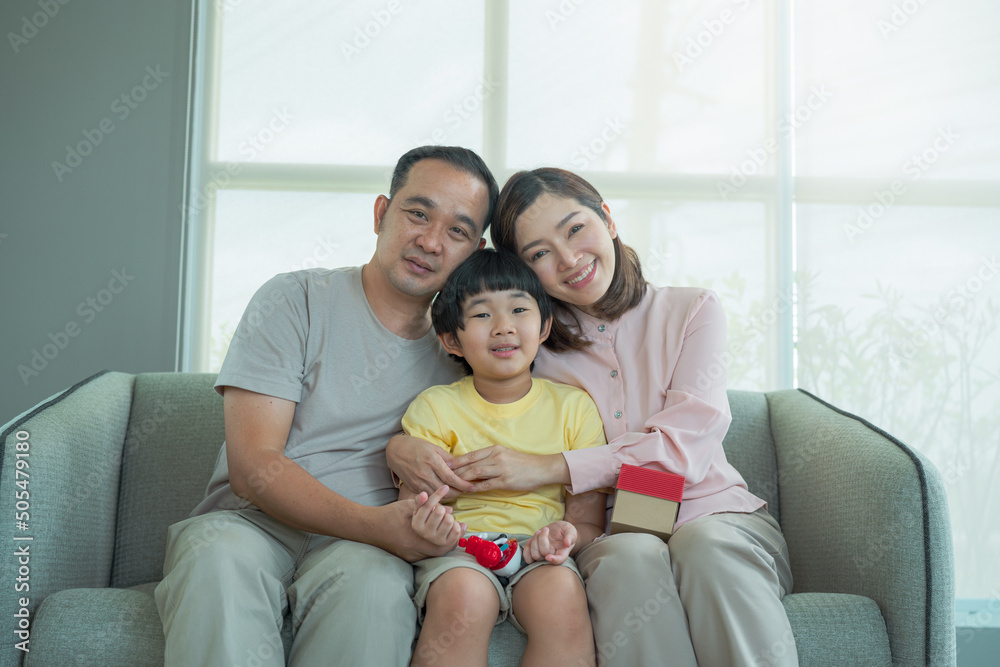 Smiling young parents and their child are very happy, Mum and dad and boys laughing and hugging. Happy family Smiling young parents and their child are very happy, Mum and dad and boys laughing and hugging. Happy family