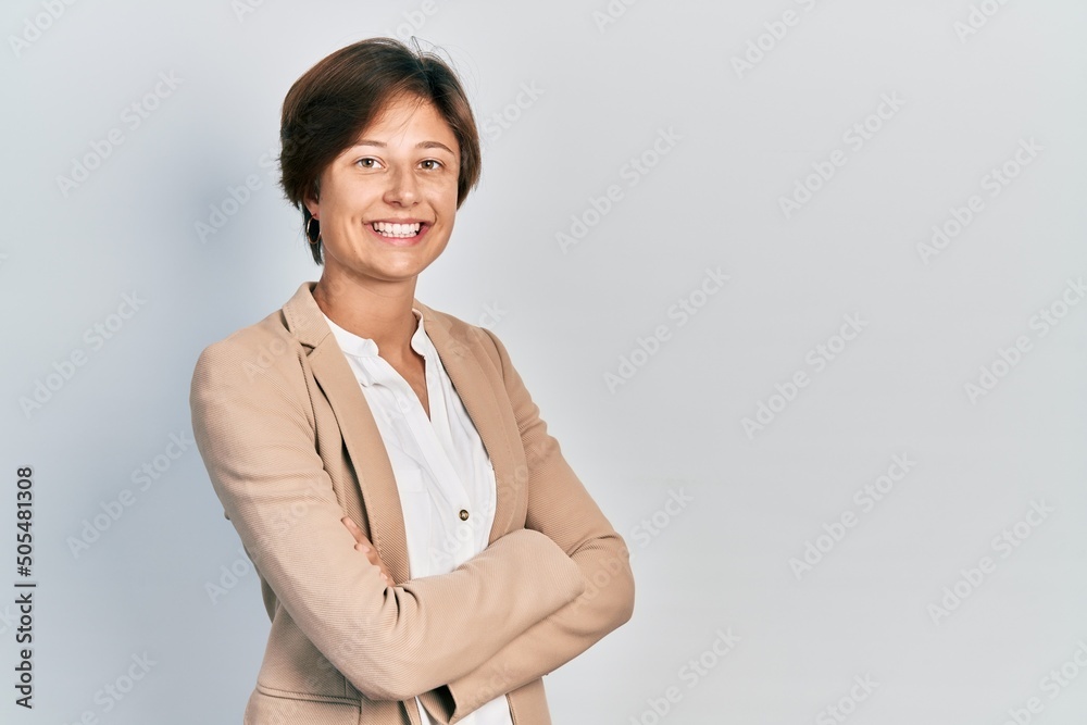 Young business woman smiling happy and confident with crossed arms standing over isolated background Young business woman smiling happy and confident with crossed arms standing over isolated background