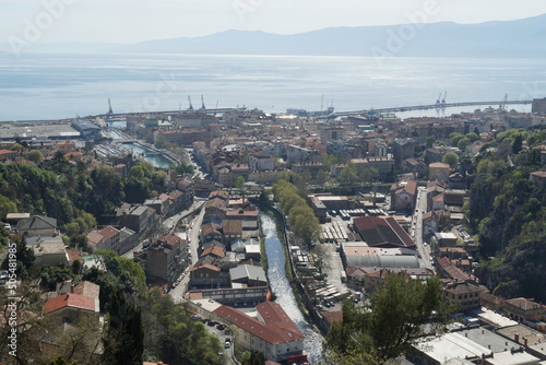 Panorama of Rijeka, the port of Croatia, from the top of Trsat castle with view on river Rjecina passing through the center. In horizon is visible Adriatic Sea and silhouette of coast.  photo