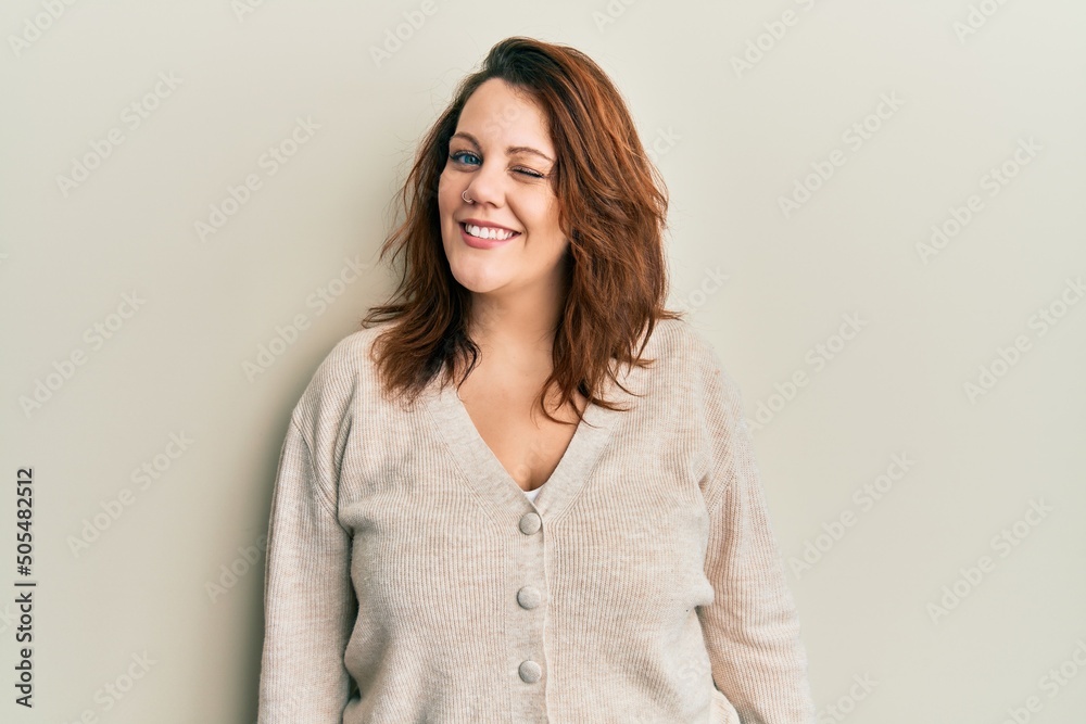 Obraz premium Young caucasian woman wearing casual clothes winking looking at the camera with sexy expression, cheerful and happy face.