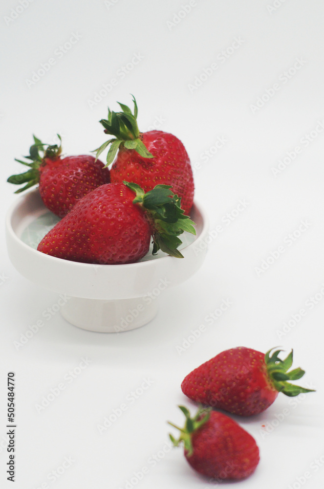 strawberries on a plate on white