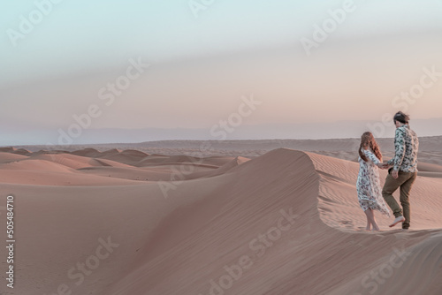 Couple in love wandering around in the desert of Oman.
