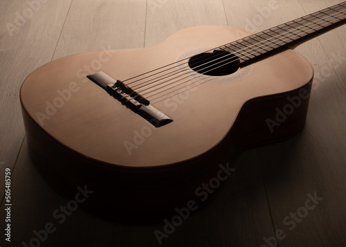 Classical guitar on a wood background