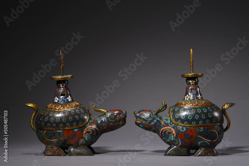 Two beautiful antique Chinese style Cloisonne gilt bronze mythical creatures on a gray background photo