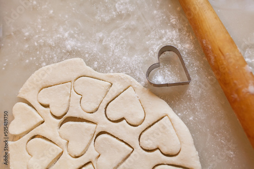 Uncooked heart shaped cookies on a table