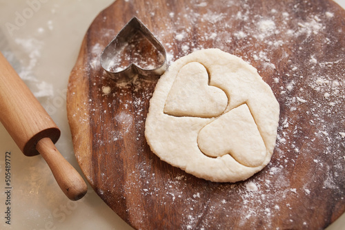 Uncooked heart shaped cookies on a table