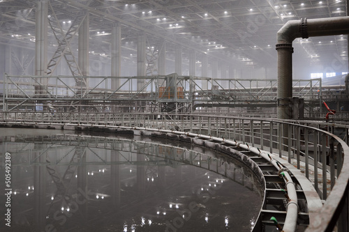 Large round floatation machine tank full of liquid at plant