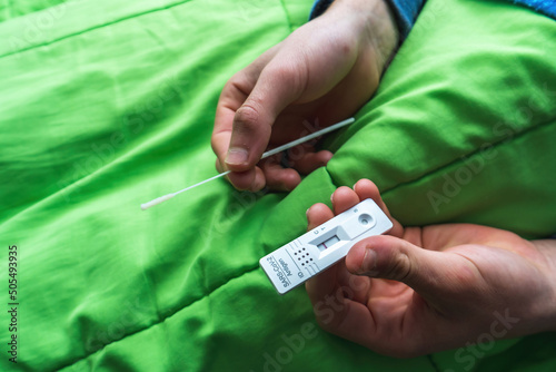 Closeup of a Covid test in a Caucasian guy's hand photo