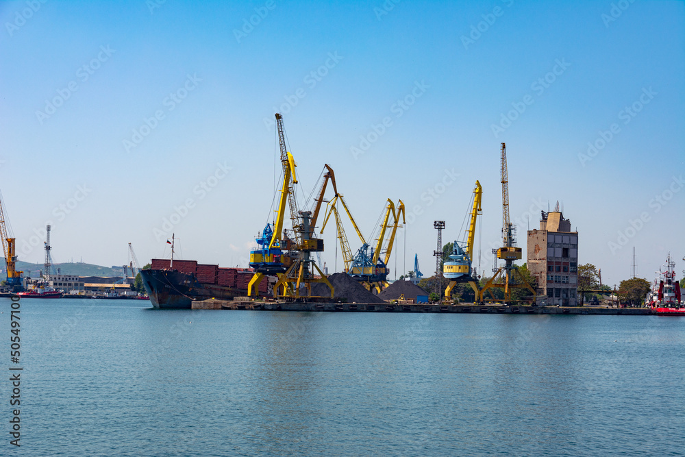 Photo of the pier and port cranes on a summer day