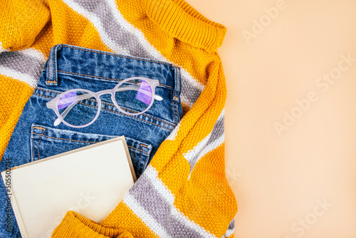 Fall flatlay with cozy sweater and book
