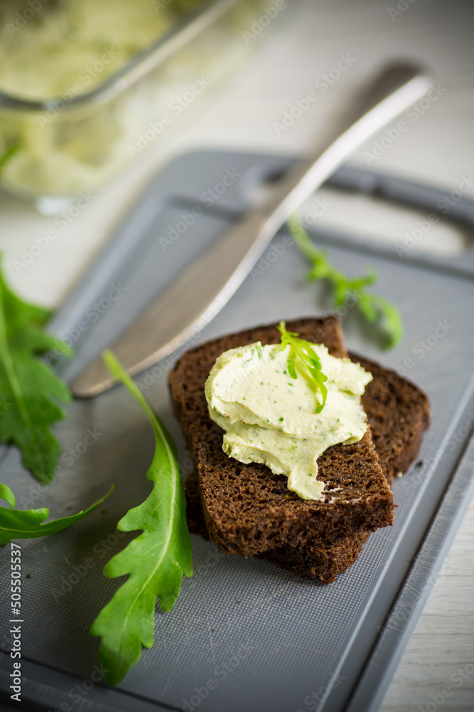 bread cheese spread with garlic and arugula on dark bread bread cheese spread with garlic and arugula on dark bread