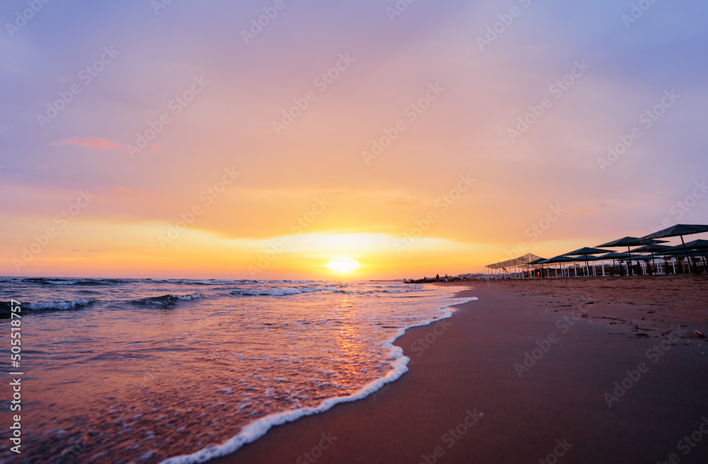 Beautiful sunset. Traveling by Turkey. Sea Beach with umbrellas.
