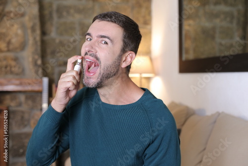 Man using breath freshener spray 