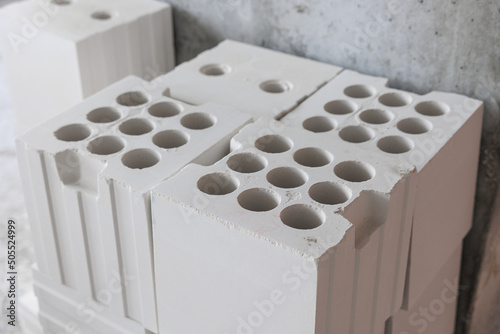 White lightweight calcium silicate bricks piled high in a stack