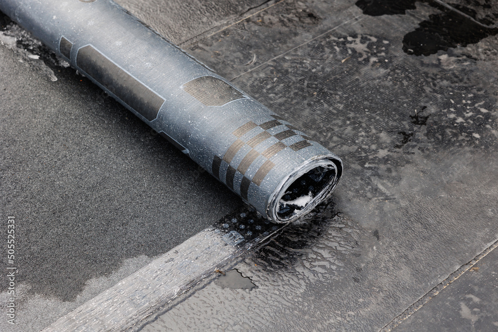 Flat Roof Installation With Propane Blowtorch During Construction Works