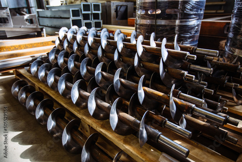 Augers. Screw machine parts in the factory photo