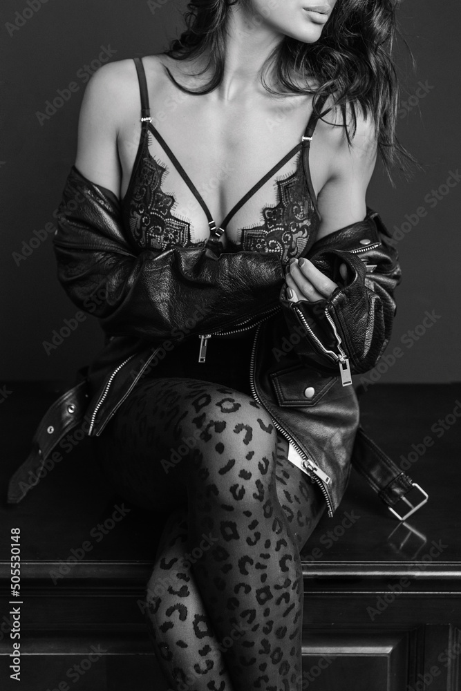Φωτογραφία woman in lace luxury lingerie and a black jacket looks away, a female with wavy