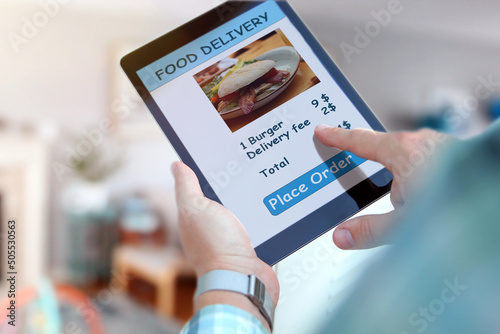 Someone is ordering food on the internet using an app, restaurant meals delivery online