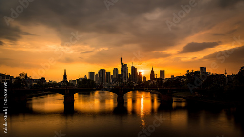 Beautiful summer view of Frankfurt skyline at golden sunset.Ignatz Bubis bridge on the river Main. photo