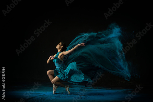 Fototapete Emotional Southeast Asian ballet dancer in a green dress performing a move on a