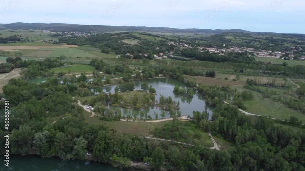 Aerial view of a field and a small lake and village in the South of France Aerial view of a field and a small lake and village in the South of France