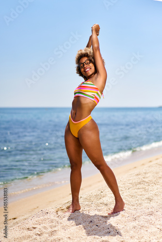 Happy woman with afro hairstyle on the sea .Vacation by the sea