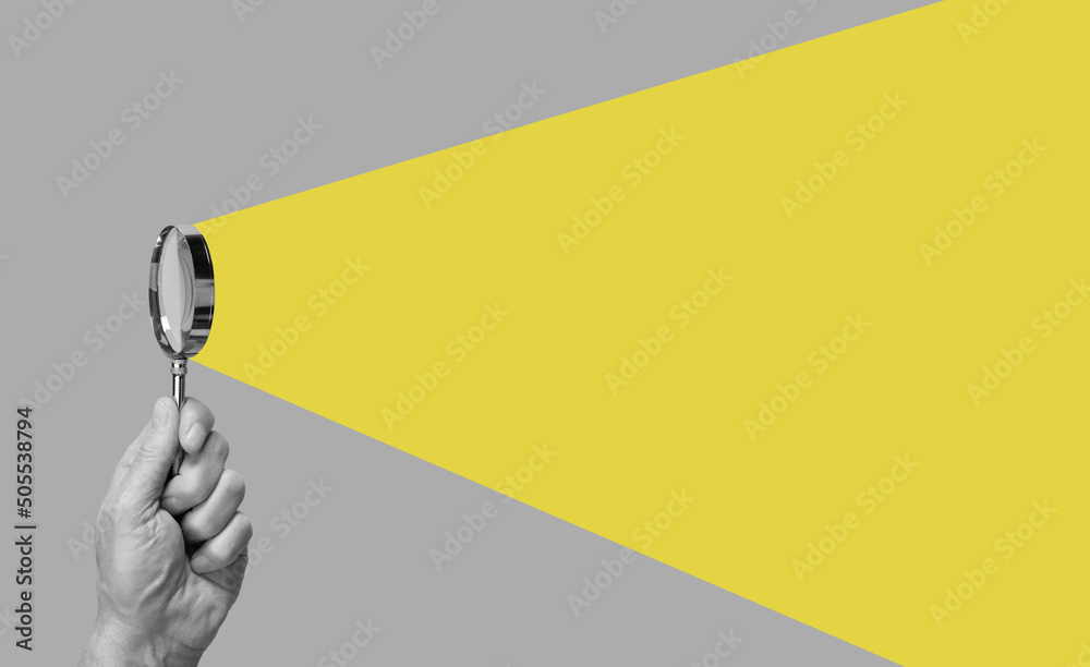 Man hand with magnifying glass. Yellow ray coming from loupe. Conducting check, information search and analysis concept. Spy, accountant, auditor job in abstract style. High quality photo - obrazy, fototapety, plakaty 