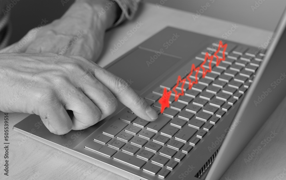 Man using laptop for giving negative feedback. One star rating of service quality, film, book, restaurant. Bad customer experience, dissatisfaction. Forefinger closeup pressing on enter button. photo Man using laptop for giving negative feedback. One star rating of service quality, film, book, restaurant. Bad customer experience, dissatisfaction. Forefinger closeup pressing on enter button. photo