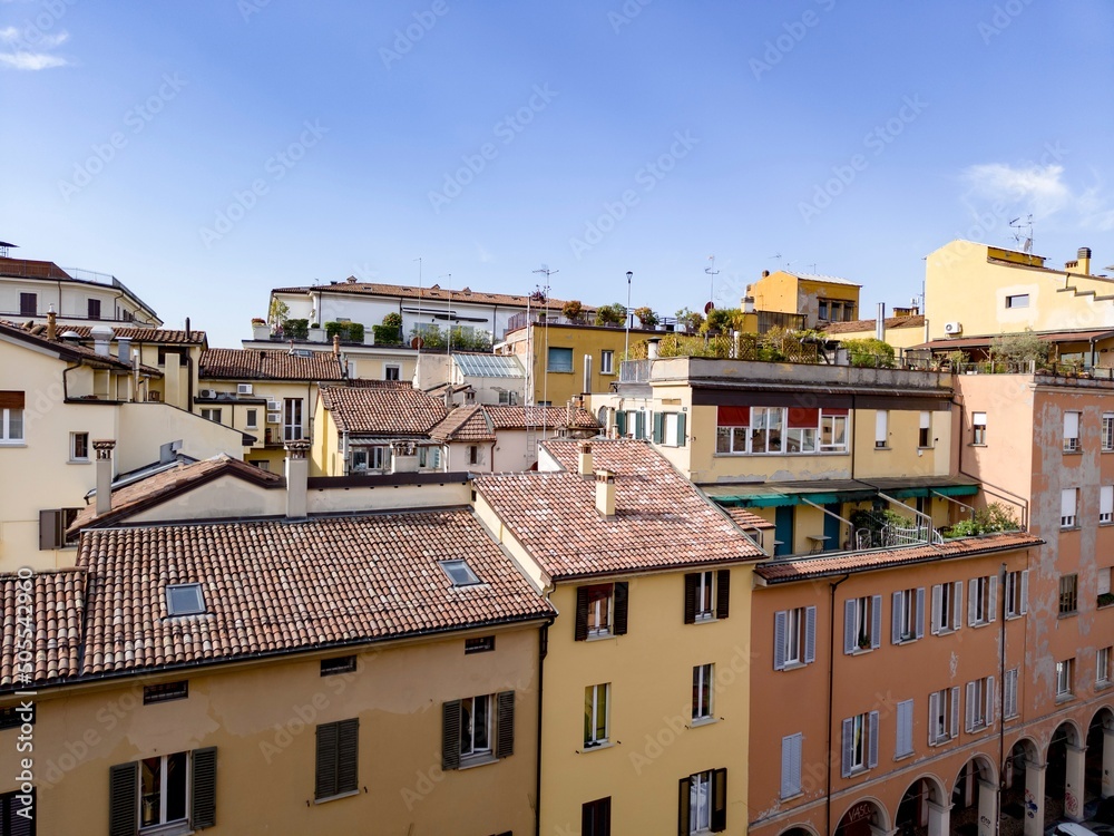 Roofs of old houses in Bologna city in Italy with balconies and terraces