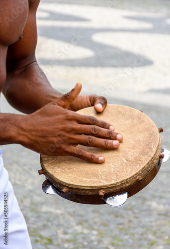 Instrumentalist playing tambourine in the streets of Pelourinho in Salvador in Bahia, Brazil