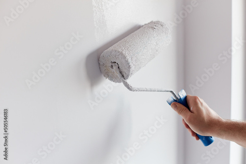 Fototapeta Naklejka Na Ścianę i Meble -  person painting a wall
