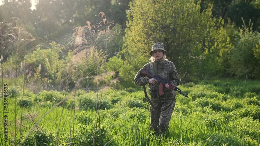 Young Ukrainian female soldier in camouflage uniform with an assault ...