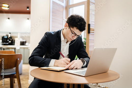 A male businessman is a manager working with a laptop in an office coworking. The lawyer draws up the documents online on the website.