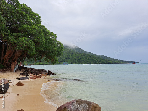 Beautiful view of a foresty mountain near the ocean photo