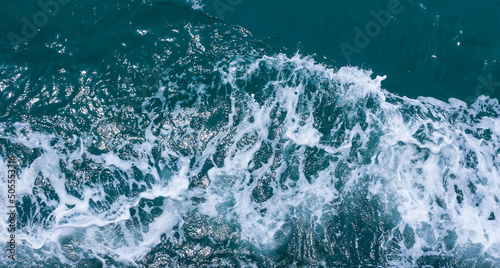 Beautiful sea waves with foam of blue and turquoise color. Abstract blue sea water with white wave. Blue and white waves of the ship road on the water sea ocean. © Duanghathai