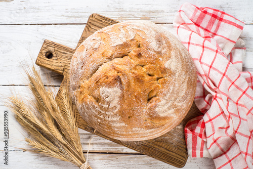 Homemade bread at white wooden table. photo