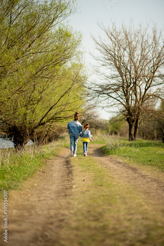 Two cute sister girls are running down an empty country road. Spring. Freedom. Childhood. Family. © Natalya Temnaya