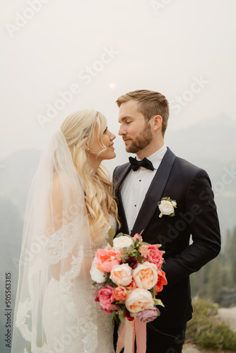 Wedding couple eloping in foggy mountains